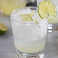 Glass of ginger limeade with a lime slice on the glass.