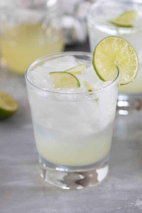 Glass of ginger limeade with a lime slice on the glass.