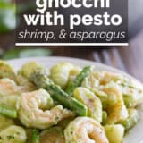 Gnocchi with pesto, shrimp, and asparagus with text overlay.