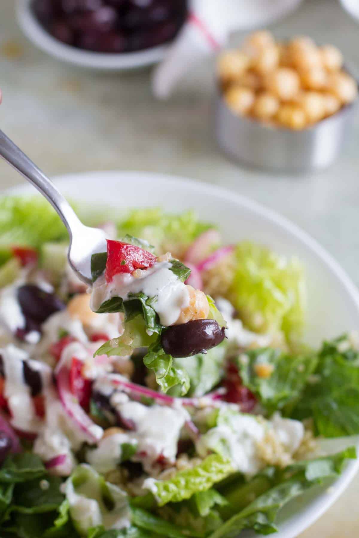 Fork full of Greek Quinoa Salad.