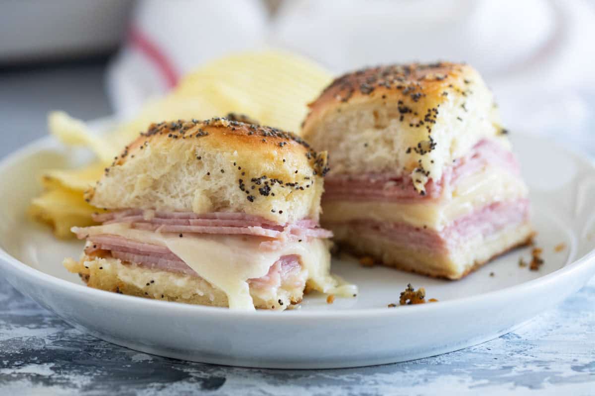 Ham and Cheese Sliders baked with poppy seeds, onions, and butter.