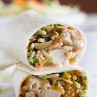 Honey sesame chicken salad wrap cut in half and stacked.