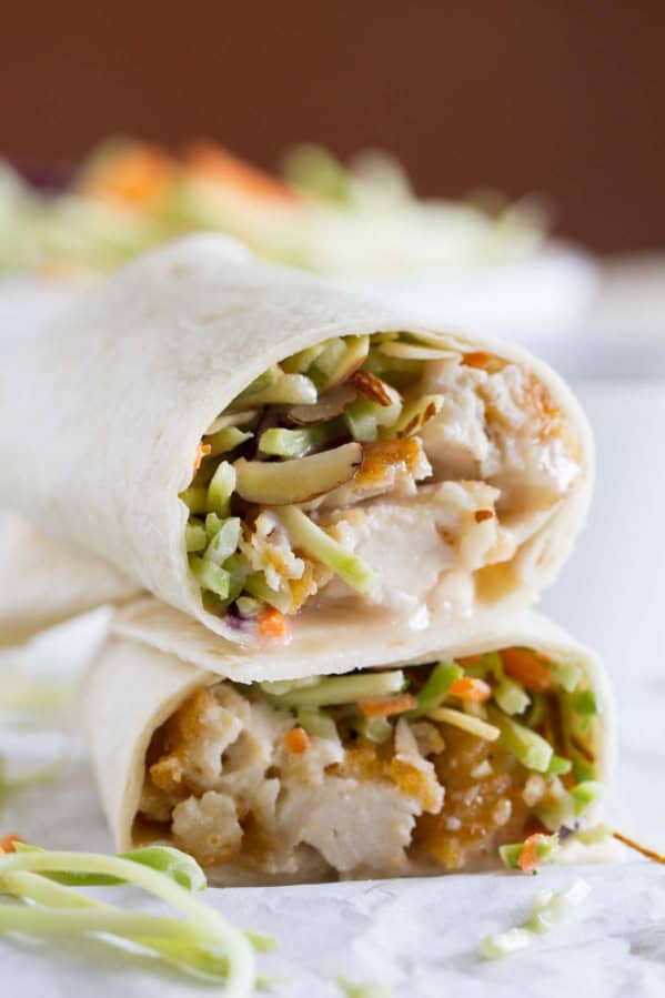 Honey sesame chicken salad wrap cut in half and stacked.