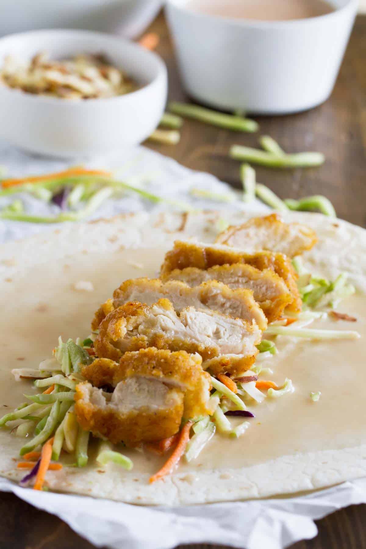 Unwrapped honey sesame chicken salad wrap with crispy chicken.