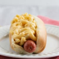 Hot dog served with homemade Mac and cheese on top.