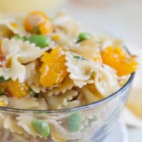 Oriental Pasta Salad with pasta, mandarin oranges, and edamame in a large glass bowl.