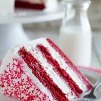 Slice of Red Velvet Ice Cream Cake with layers of red velvet cake and cheesecake ice cream.