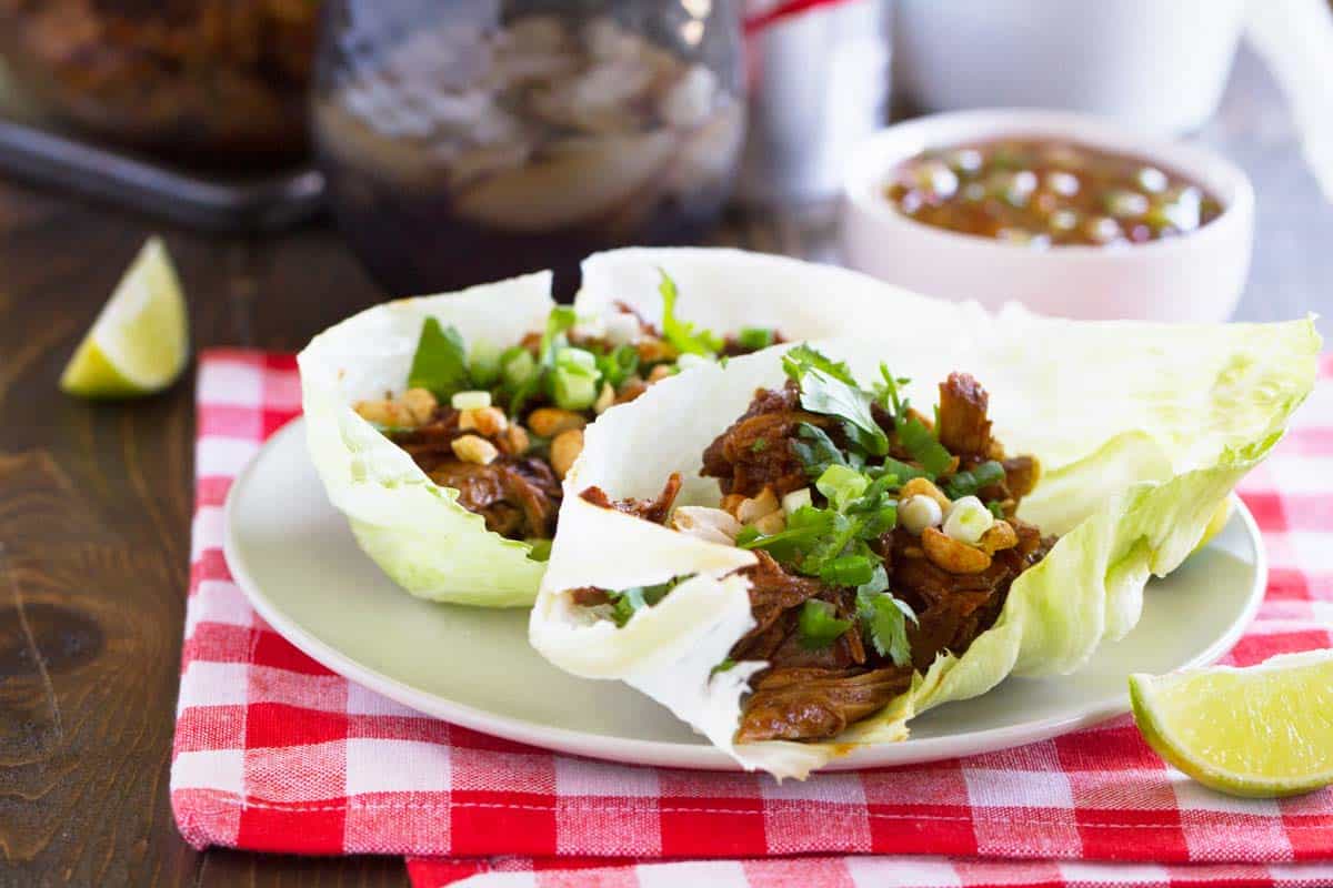 BBQ Pork Lettuce Wraps topped with peanuts, green onions, and cilantro.