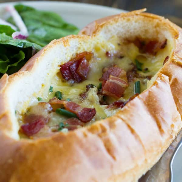 Baked Egg, Bacon, and Cheese Boat topped with more bacon and chives.