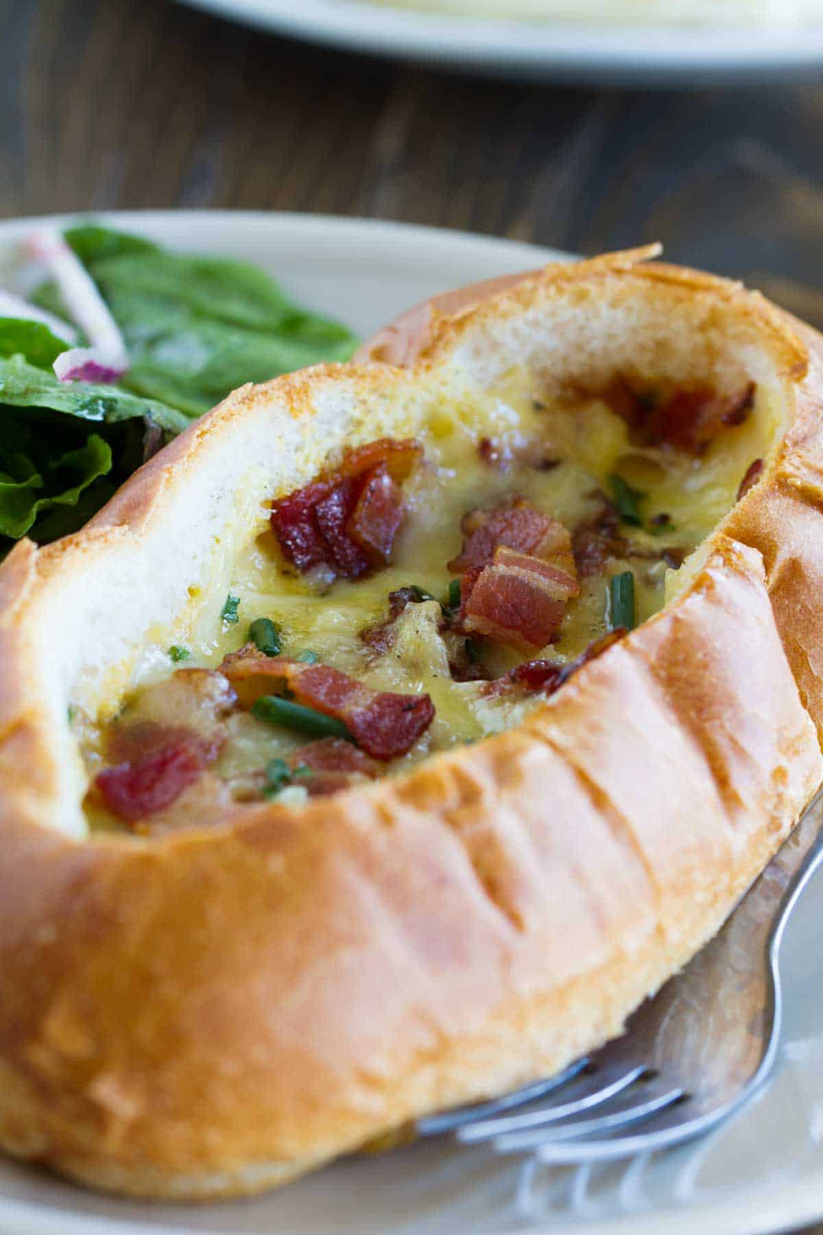 Baked Egg, Bacon, and Cheese Boat topped with more bacon and chives.