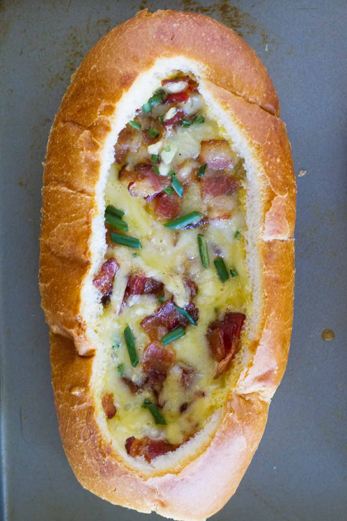 Submarine roll filled with baked eggs, bacon, and cheese.