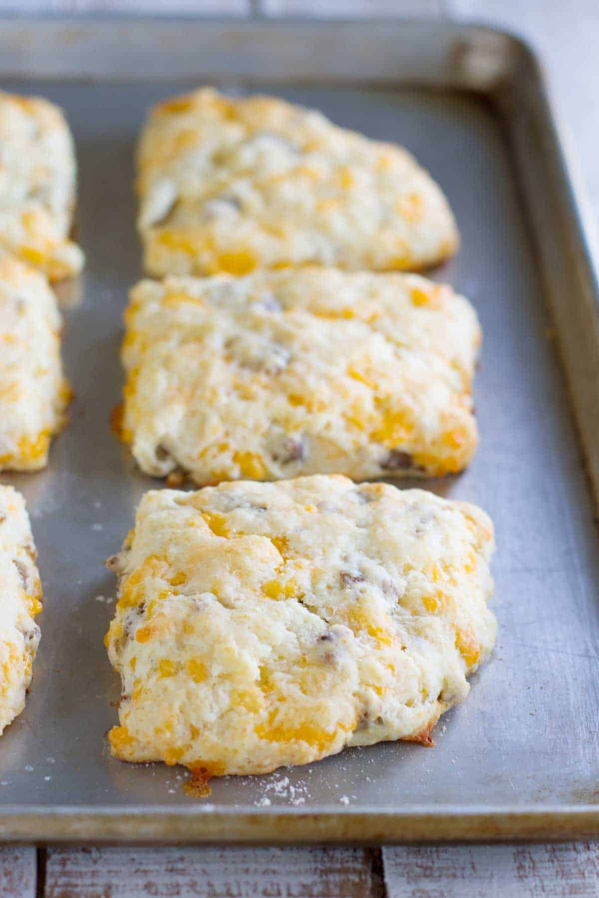 Cheddar Sausage Biscuits on a baking tray.