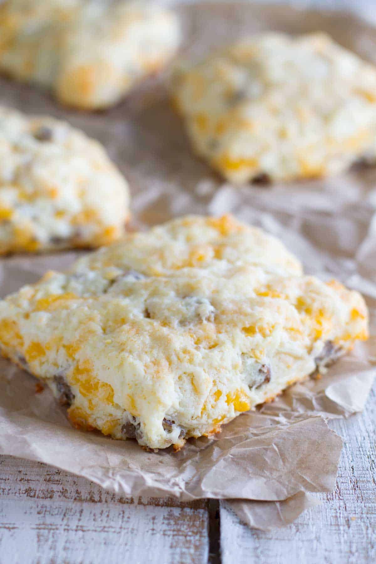 Cheddar Sausage Biscuits on parchment paper.