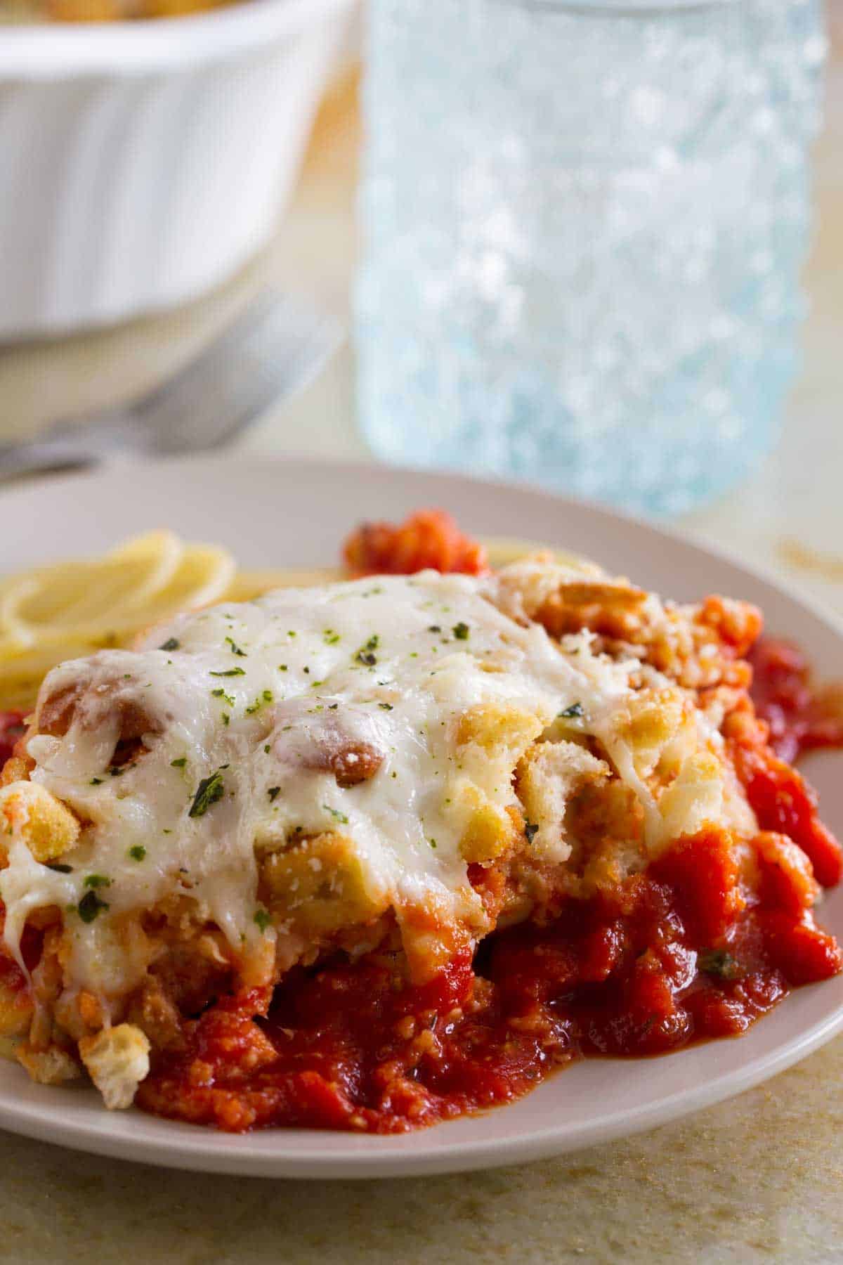 Chicken Parmesan Casserole - an easier version of chicken parmesan, served over spaghetti noodles.