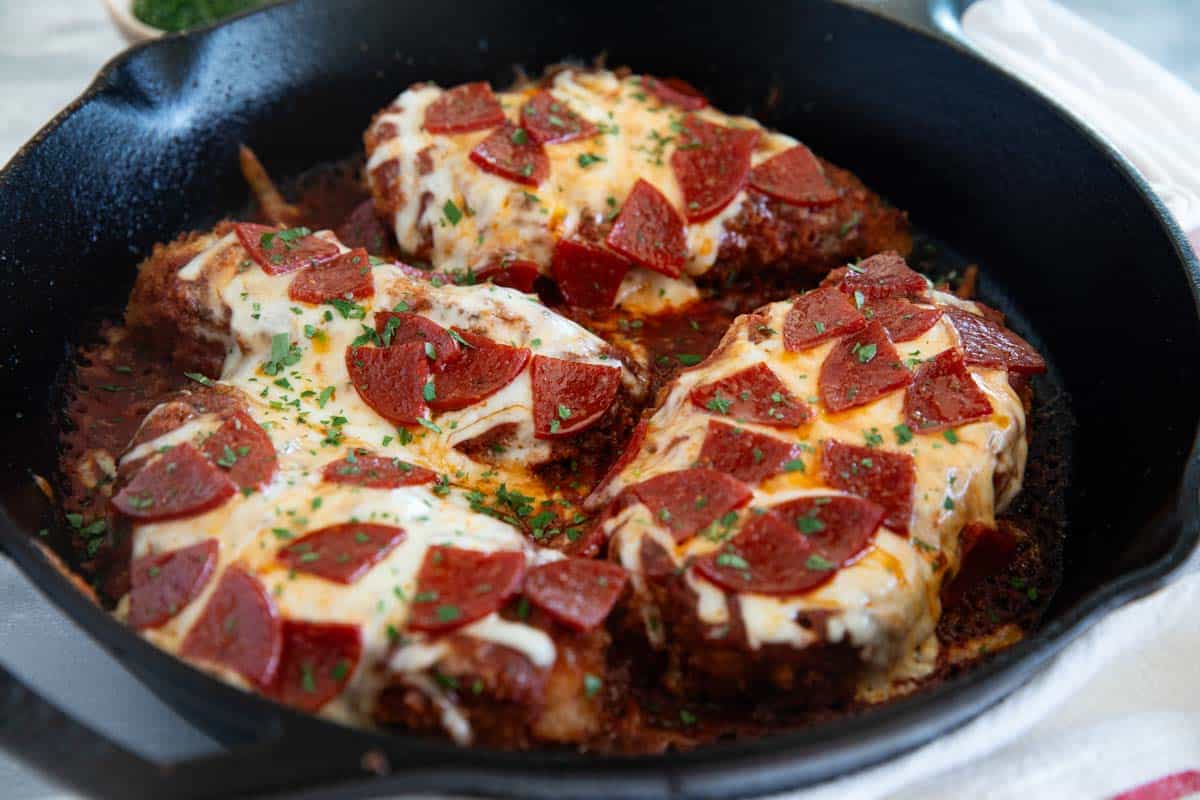 Chicken Pepperoni topped with cheese and pepperoni in a skillet.