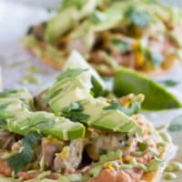 Chicken Tostadas with Poblano Cream Sauce, topped with avocado and cilantro.