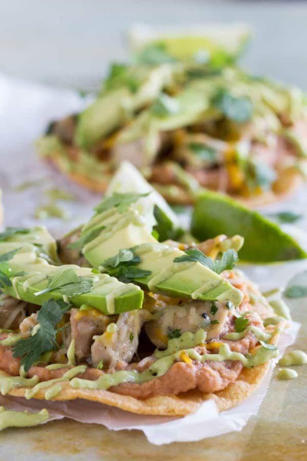 Chicken Tostadas with Poblano Cream Sauce, topped with avocado and cilantro.