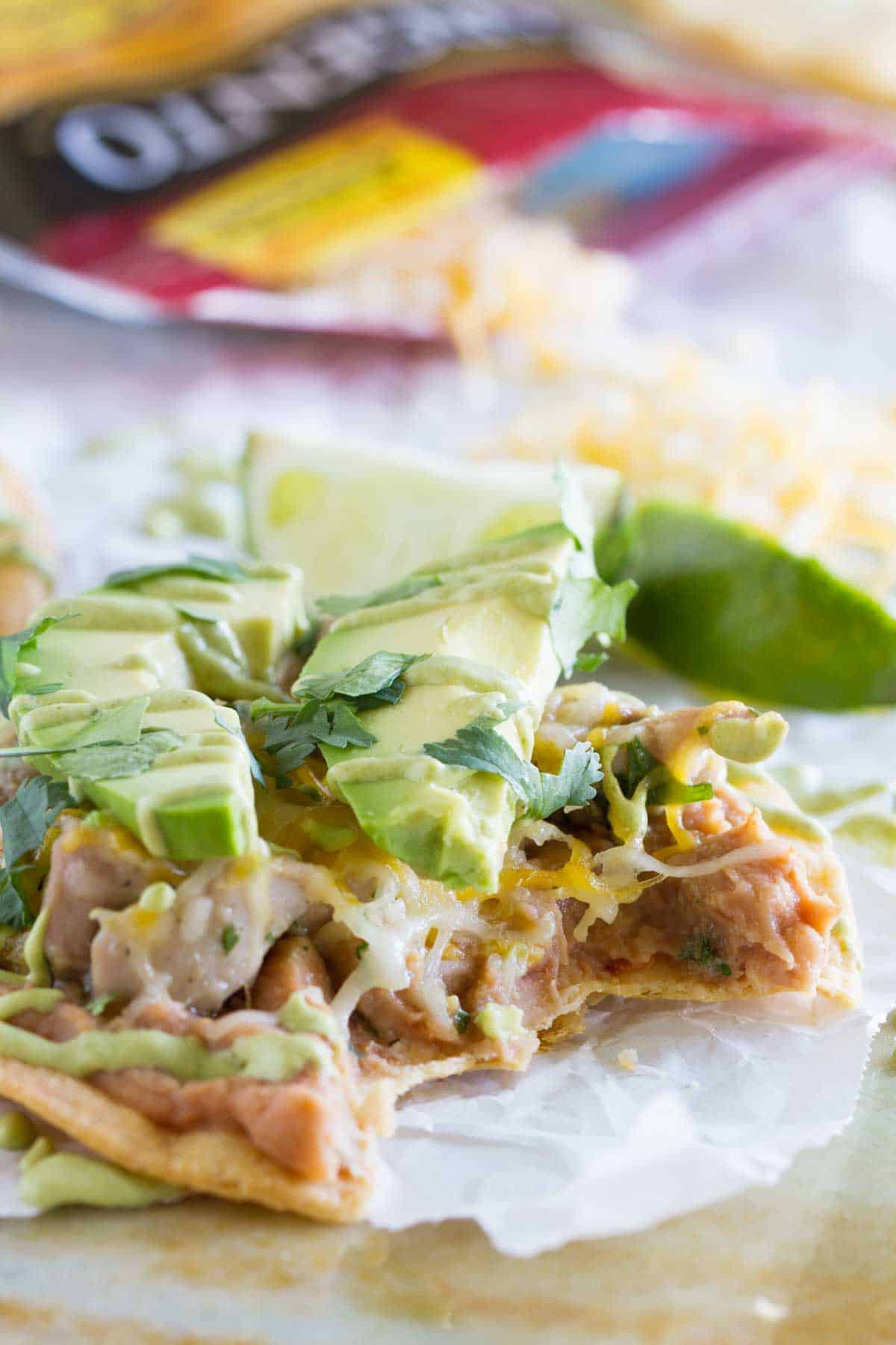 Chicken Tostadas with Poblano Cream Sauce with a bite taken from it.