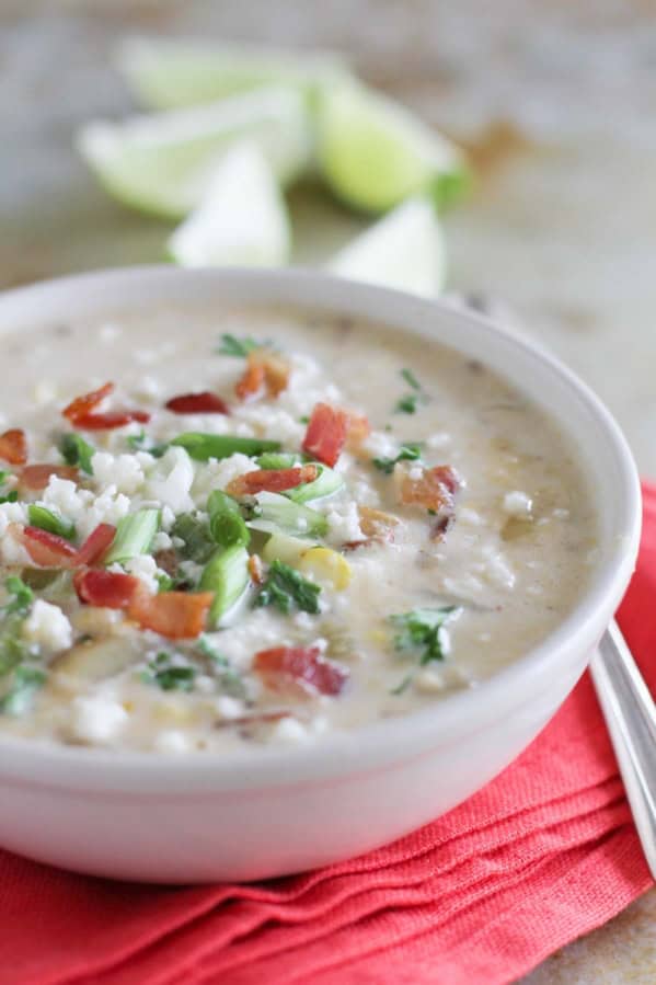 Bowl of Chipotle Corn Chowder topped with bacon, green onions, and cheese.