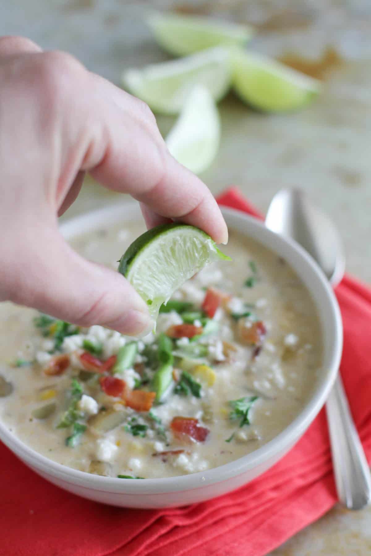 Squeezing fresh lime into Chipotle Corn Chowder.