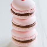 Three Chocolate Cherry French Macarons stacked on top of each other.