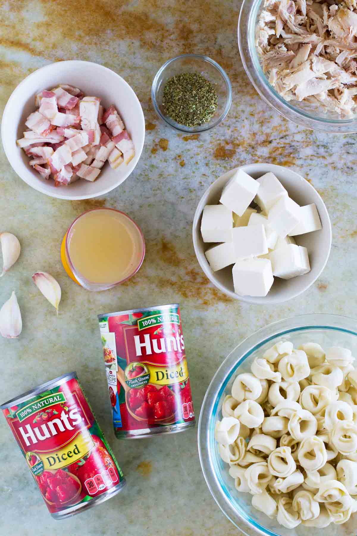 Ingredients to make Creamy Tomato Tortellini with Chicken and Bacon.