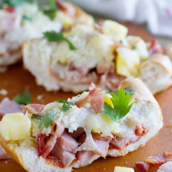 Slice of French Bread Hawaiian Pizza with ham, pineapple, and bacon.