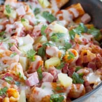 Hawaiian One Pan Pasta with ham, bacon, pineapple, and cilantro.