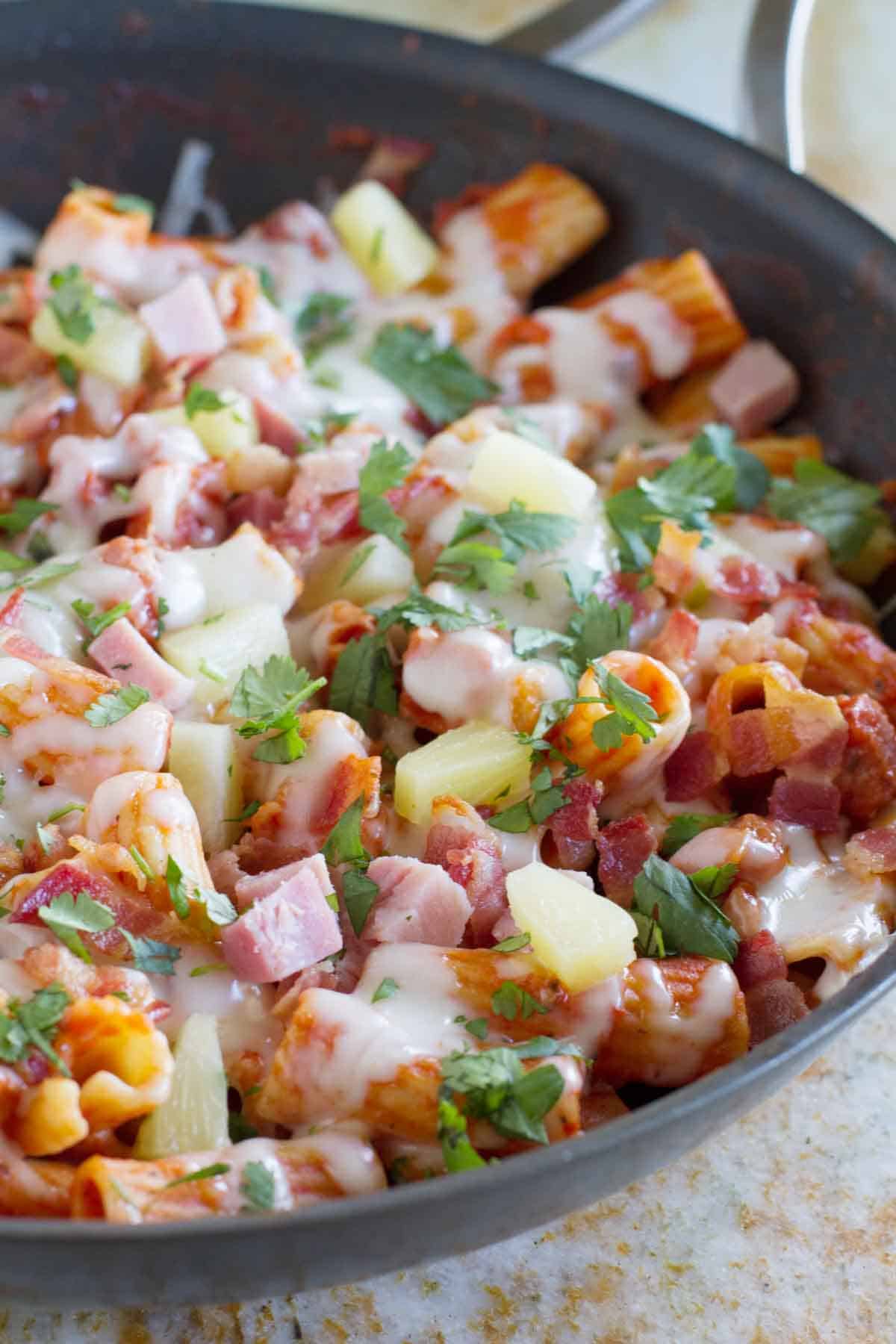 Hawaiian One Pan Pasta with ham, bacon, pineapple, and cilantro.