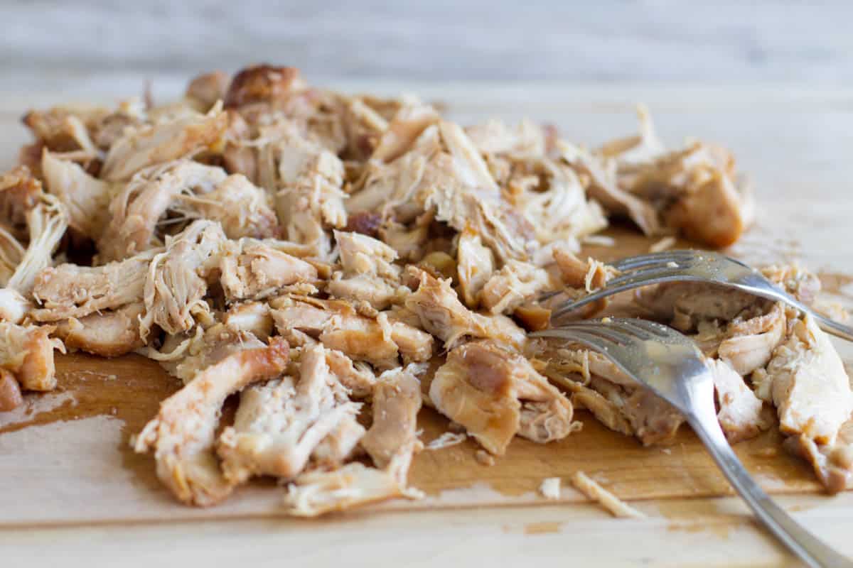 Shredding chicken thighs for Honey Garlic Chicken Tacos.