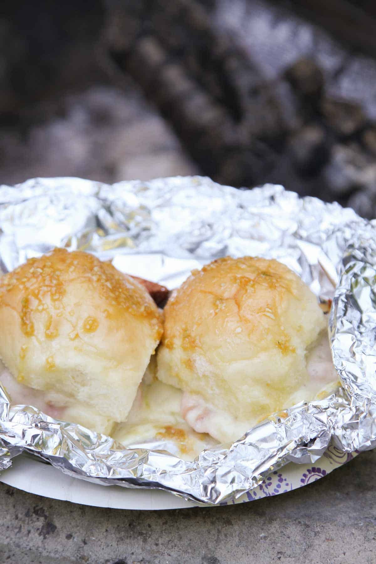 Hot Ham and Cheese Campfire Sandwiches with melted cheese in foil.