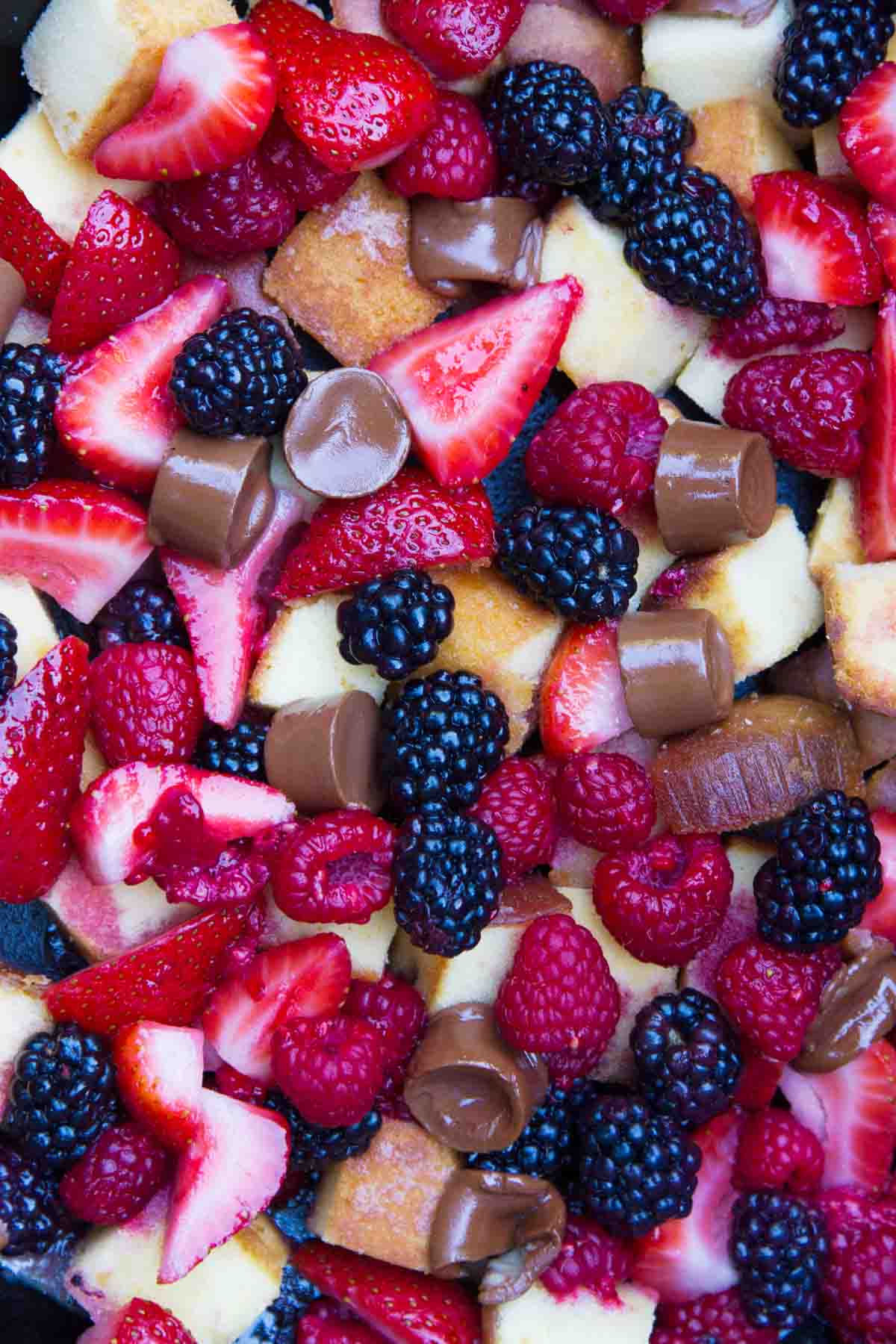 Close up of Pound Cake and Berry Campfire Skillet Dessert with Rolls.