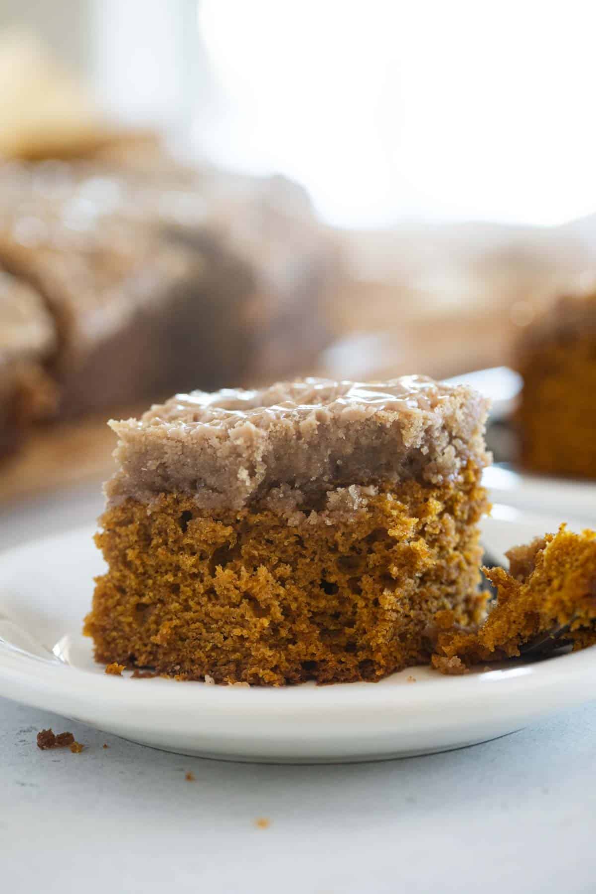 Slice of pumpkin coffee cake with a bite taken from it.