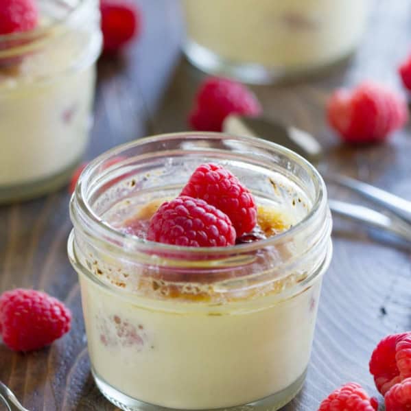 Raspberry Creme Brûlée topped with fresh raspberries in a jar.