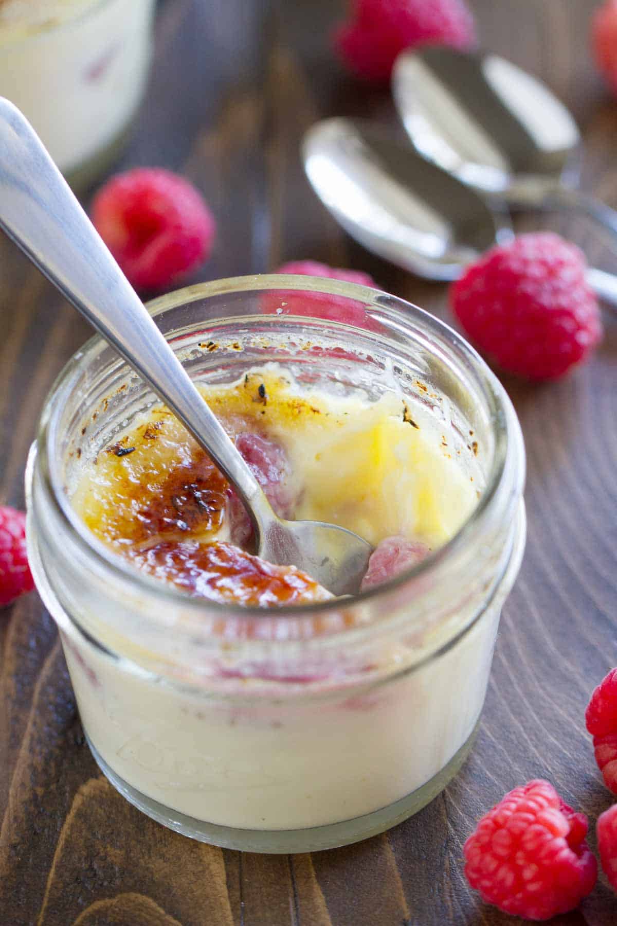 Raspberry Creme Brûlée with a bite taken from it.