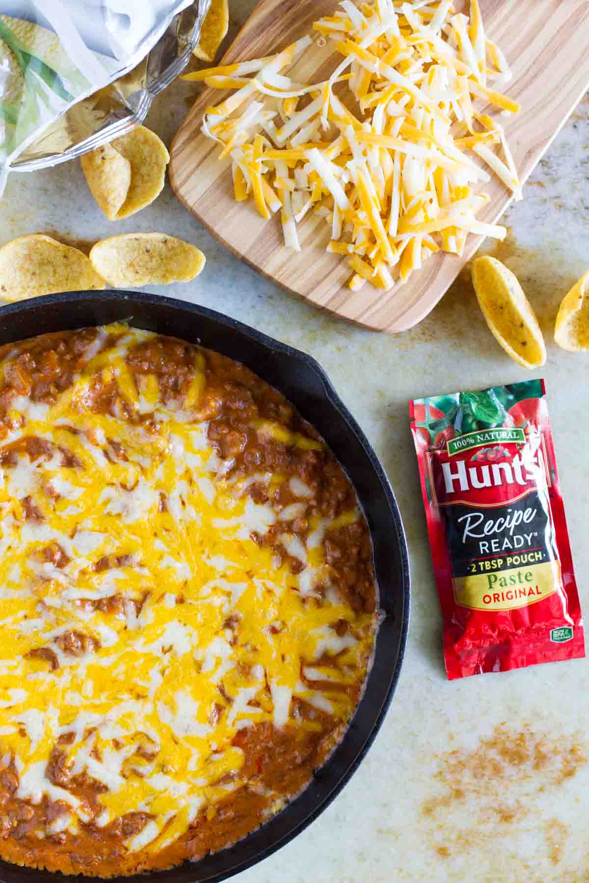 Sloppy Joe Dip in a skillet with tomato paste pouch placed next to it.