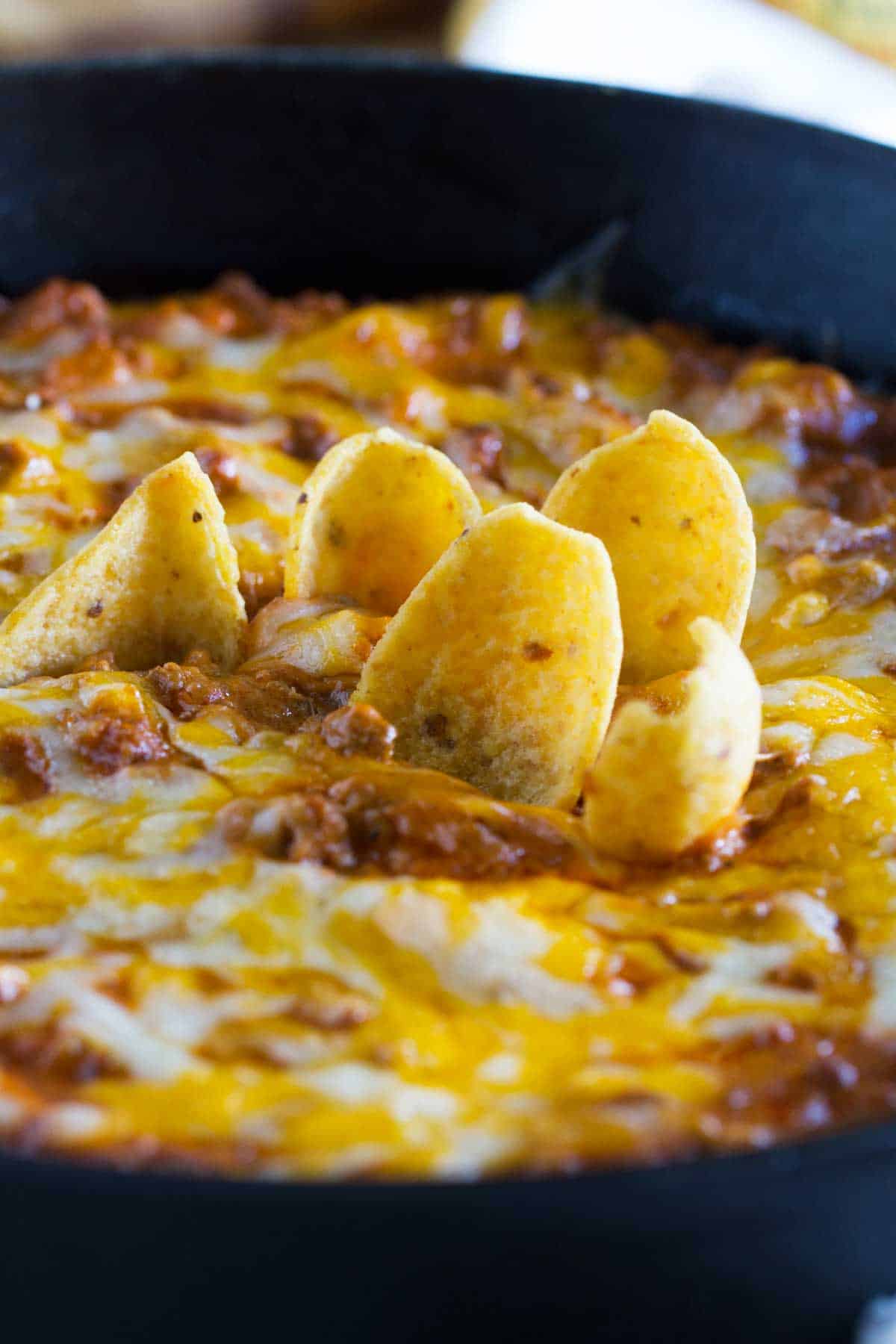 Sloppy Joe Dip with corn chips stuck into it.