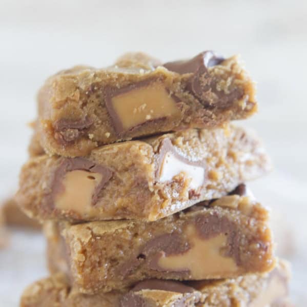 4 Spice Cake Caramel Blondies stacked on top of each other.