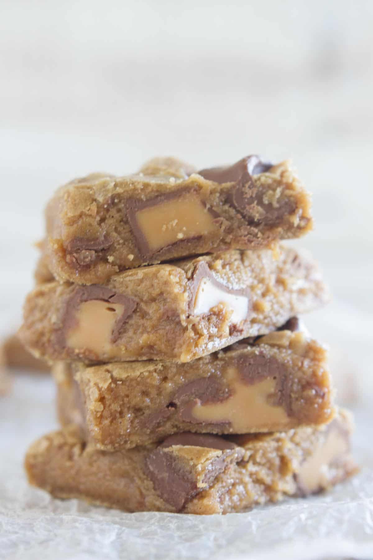 4 Spice Cake Caramel Blondies stacked on top of each other.