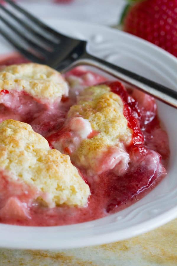 Serving of Strawberry Cobbler with Cream Cheese in a shallow bowl.