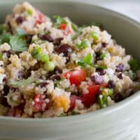 Tomato and Black Bean Quinoa Salad with green onions and cilantro on top.