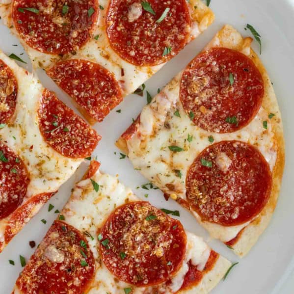 Tortilla Pizza on a plate, cut into 4 pieces.