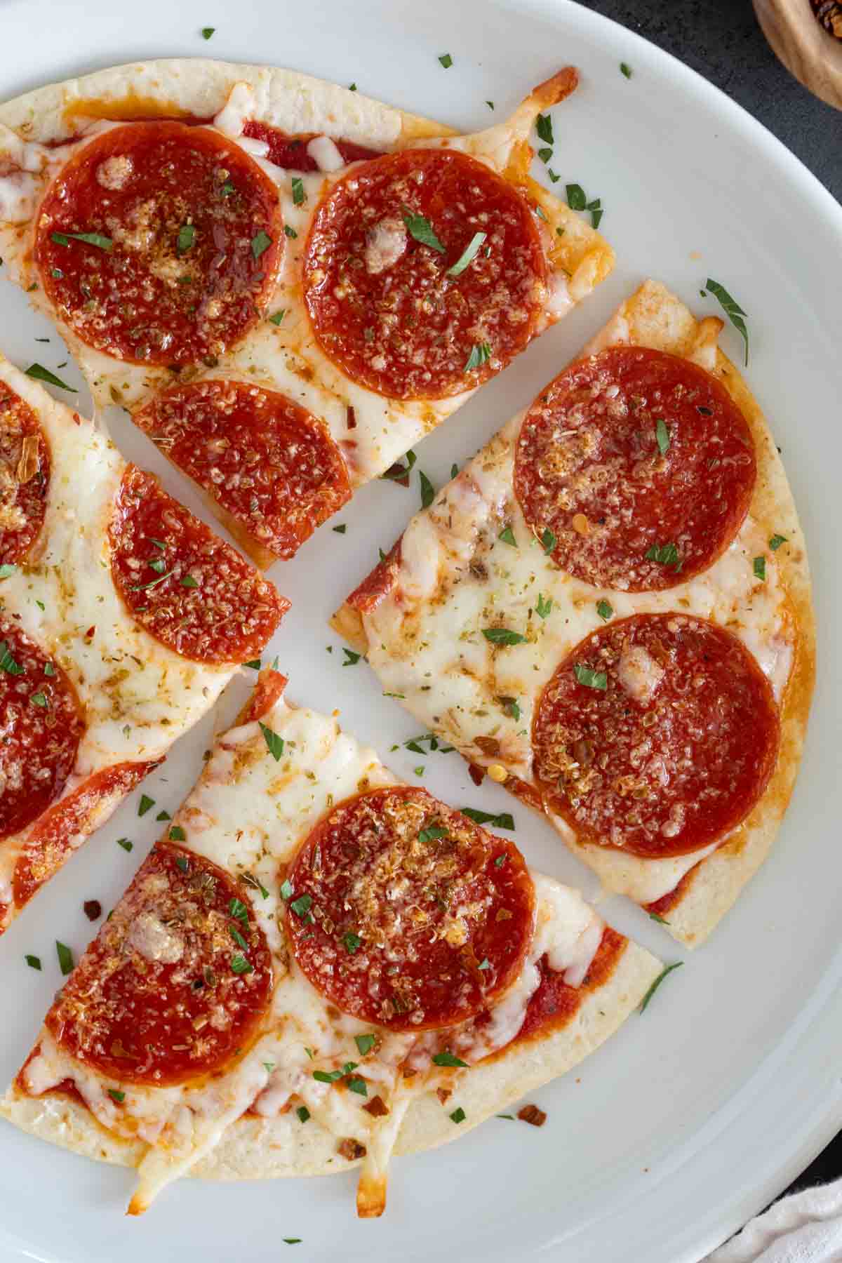 Tortilla Pizza on a plate, cut into 4 pieces.