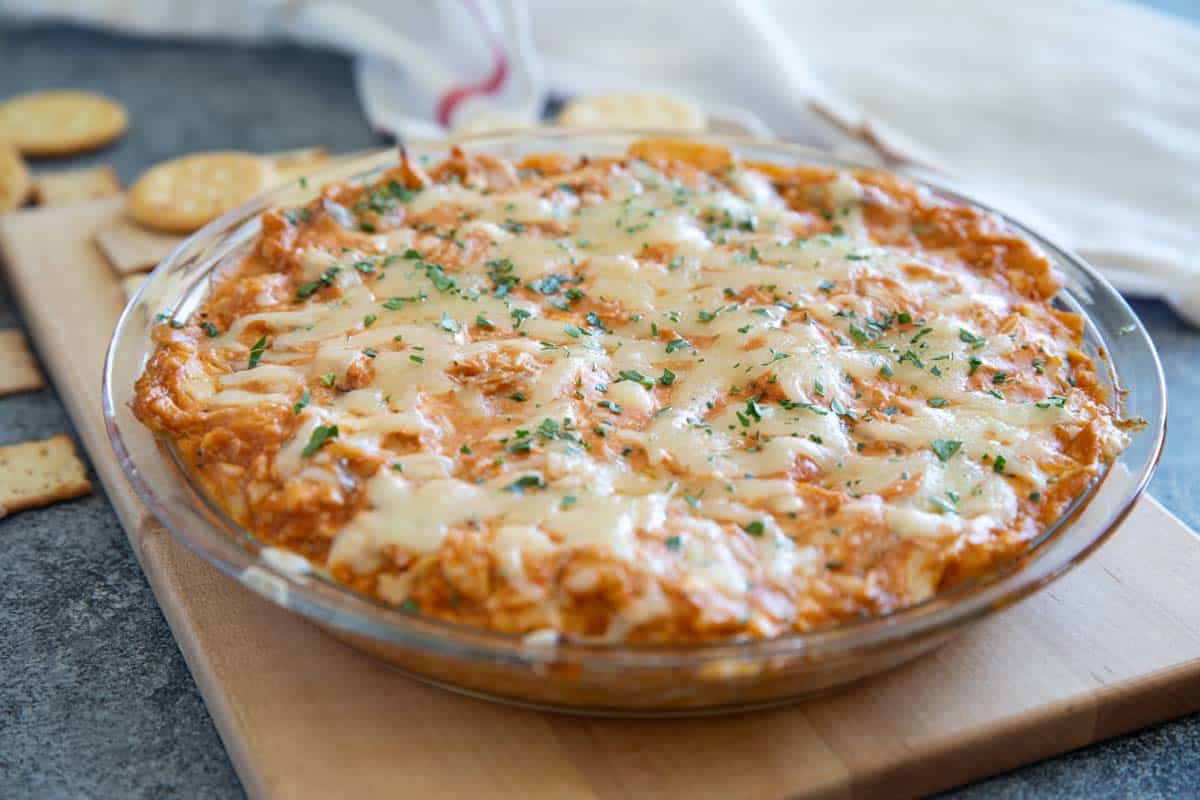 BBQ Chicken Dip in a glass pie plate, topped with melted cheese.