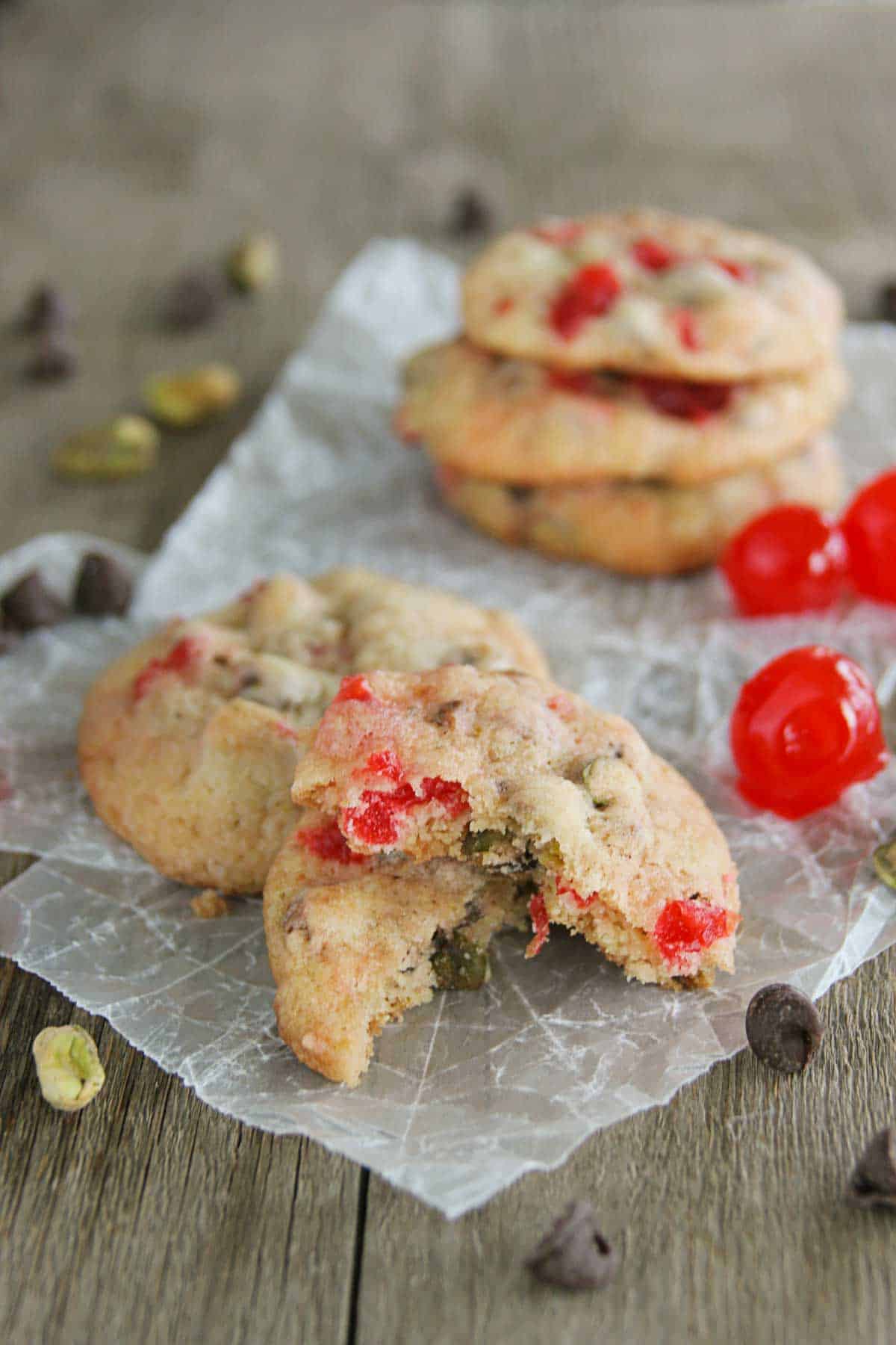 Cherry Chocolate Nut Cookie broken in half, sitting on another cookie.