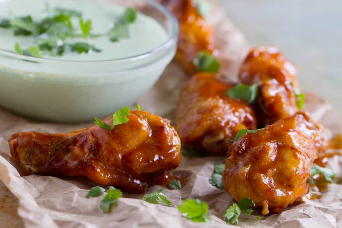 Enchilada Chicken Wings with cilantro and cilantro dipping sauce.