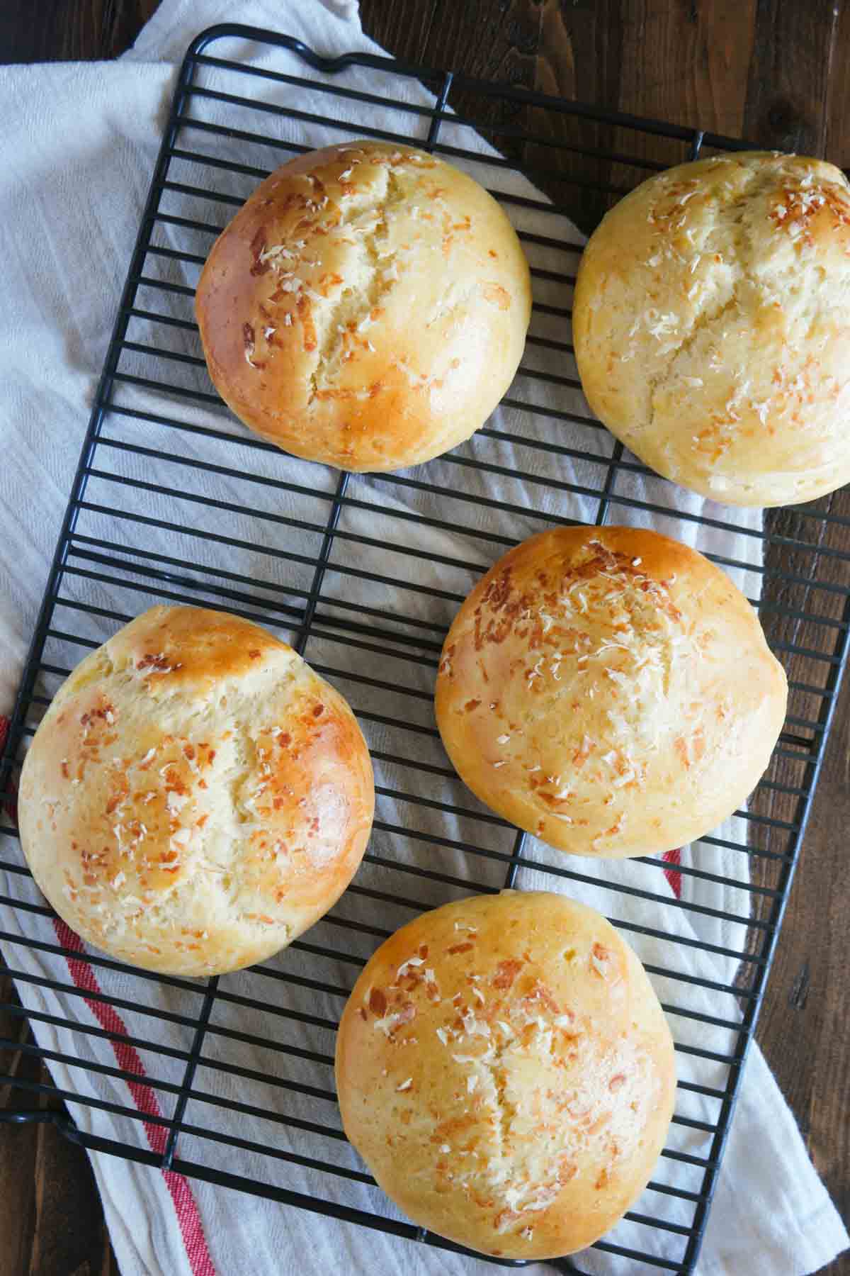 Garlic Parmesan Brioche Buns cooling on a cooling rack.