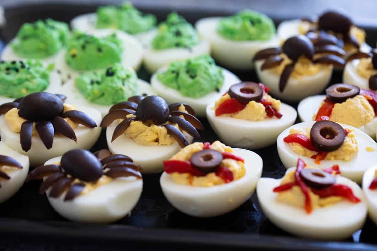 Halloween Deviled Eggs - made three ways with spider eggs, green eggs, and eyeball eggs.