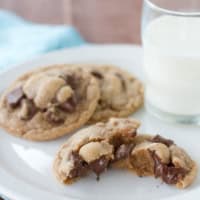 Malted Chocolate Chunk Cookies on a plate, with one broken in half.