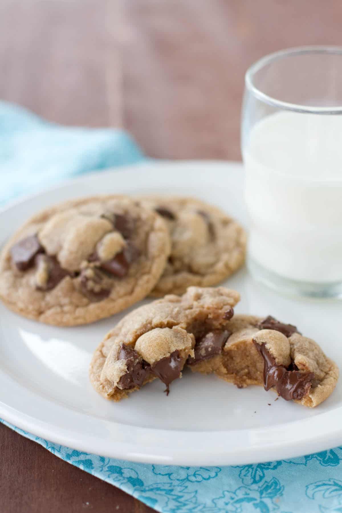 Malted Chocolate Chunk Cookies on a plate, with one broken in half.